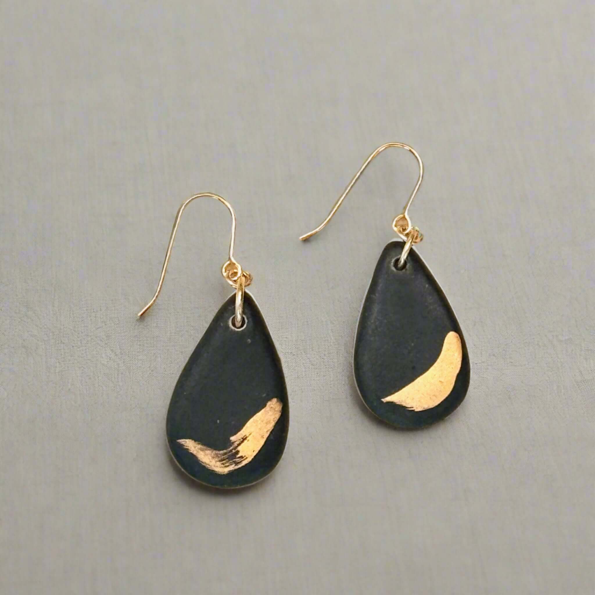 small teardrop shaped black and gold earring