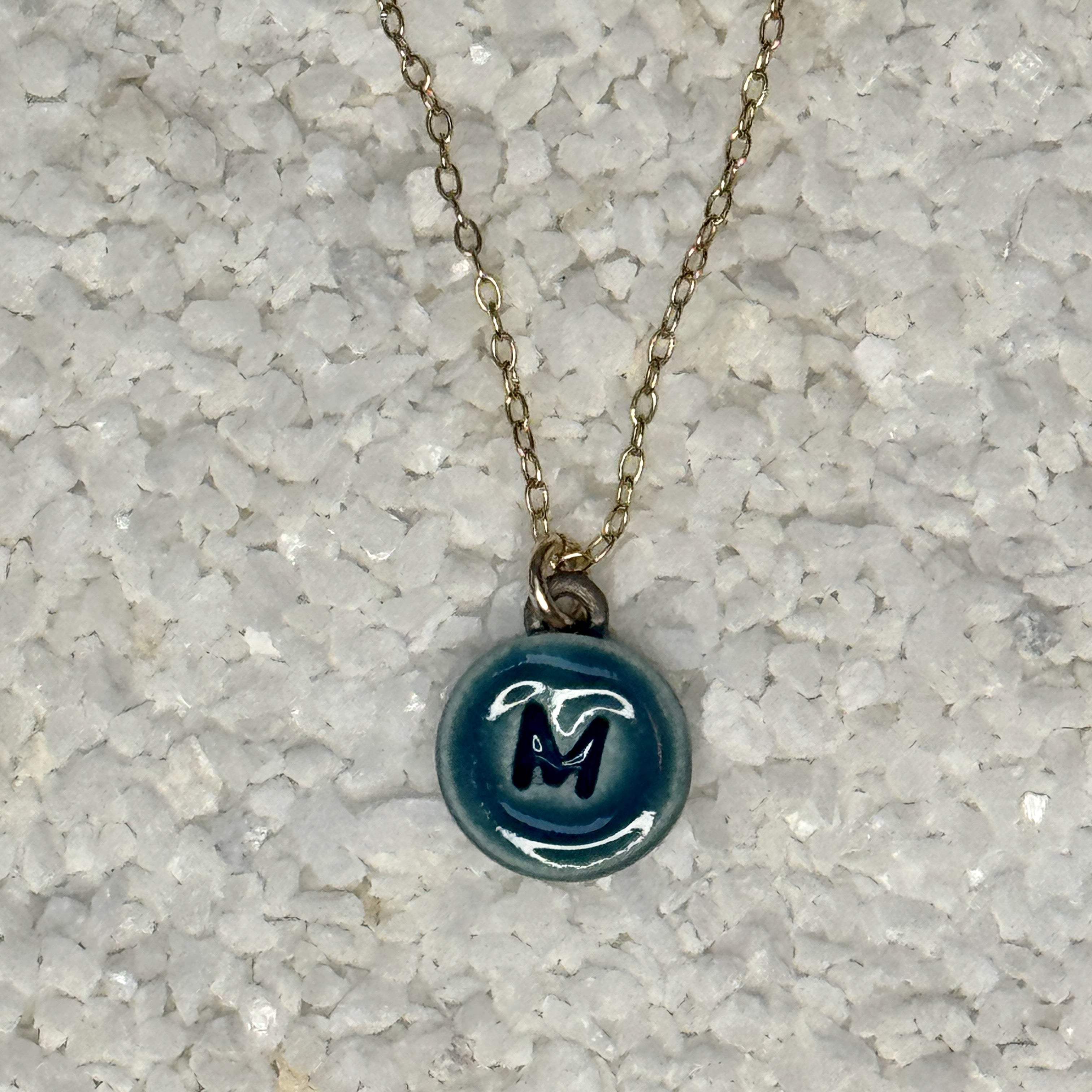 small circular teal letter charm necklace