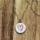 white circle necklace with red heart