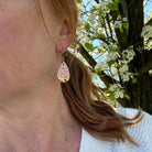 model wearing coral pink teardrop  earrings with gold accent