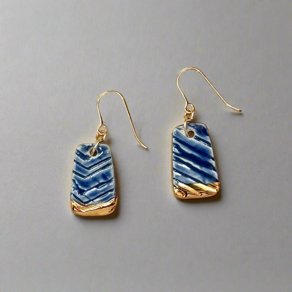 textured royal blue earring with gold accent dangle