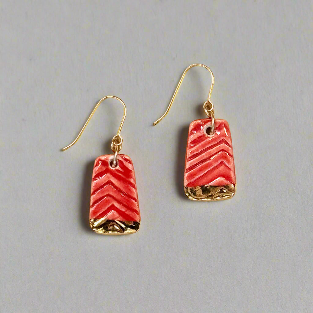 textured red earring with gold accent